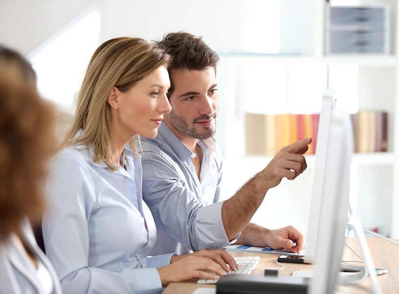 Man and woman checking computer screen
