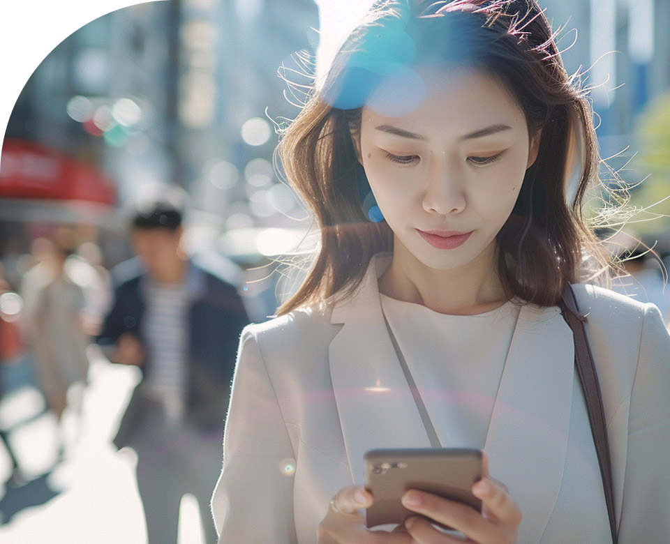 Person looking at mobile phone, urban outdoor