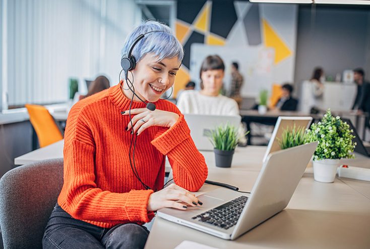 Woman with headset in big modern office